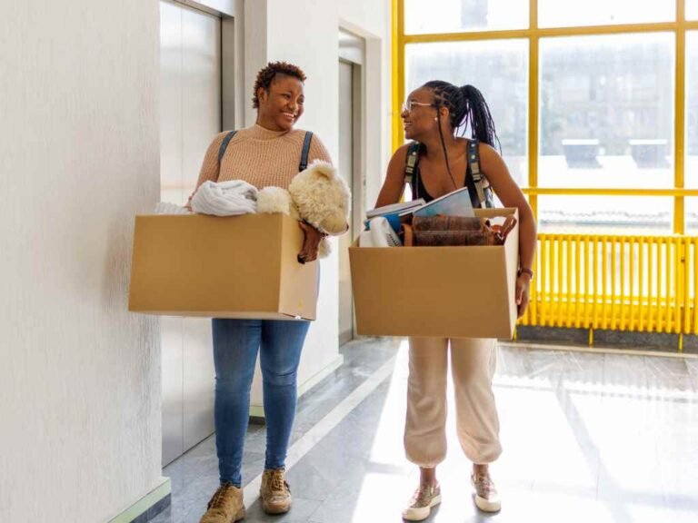 two female college students moving in to their dorm