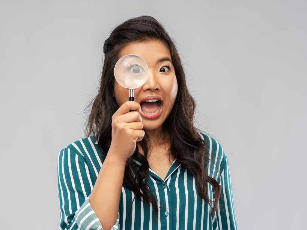 asian woman with magnifying glass