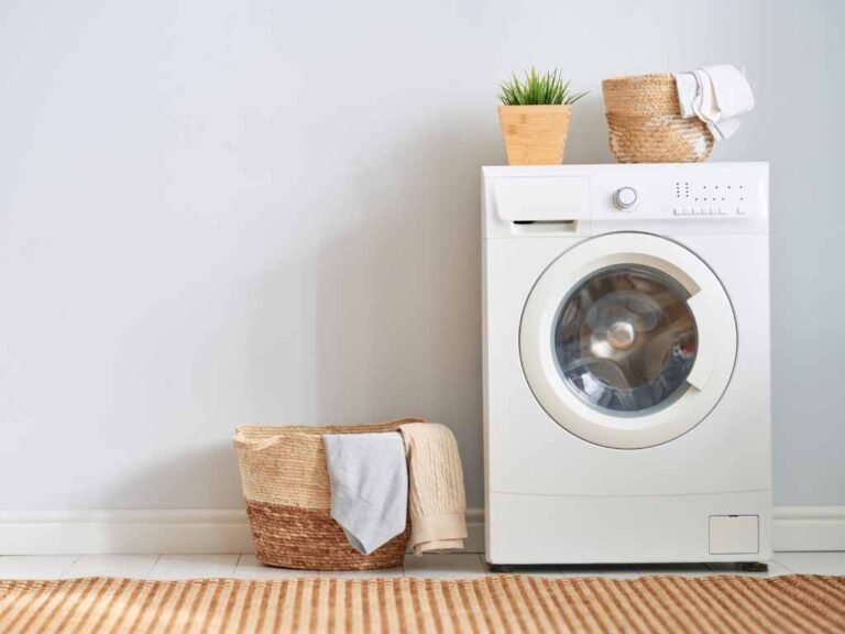 white aesthetic washing machine with a clothes hamper on the side