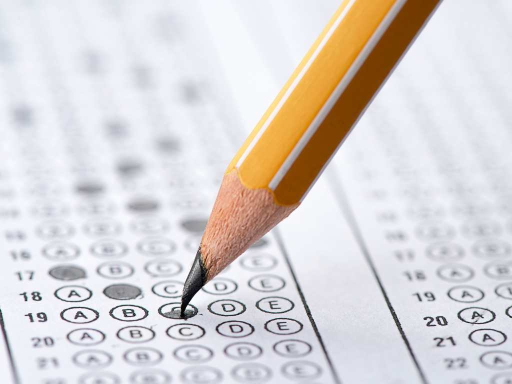 exam sheet with penciled-in dots and a pencil