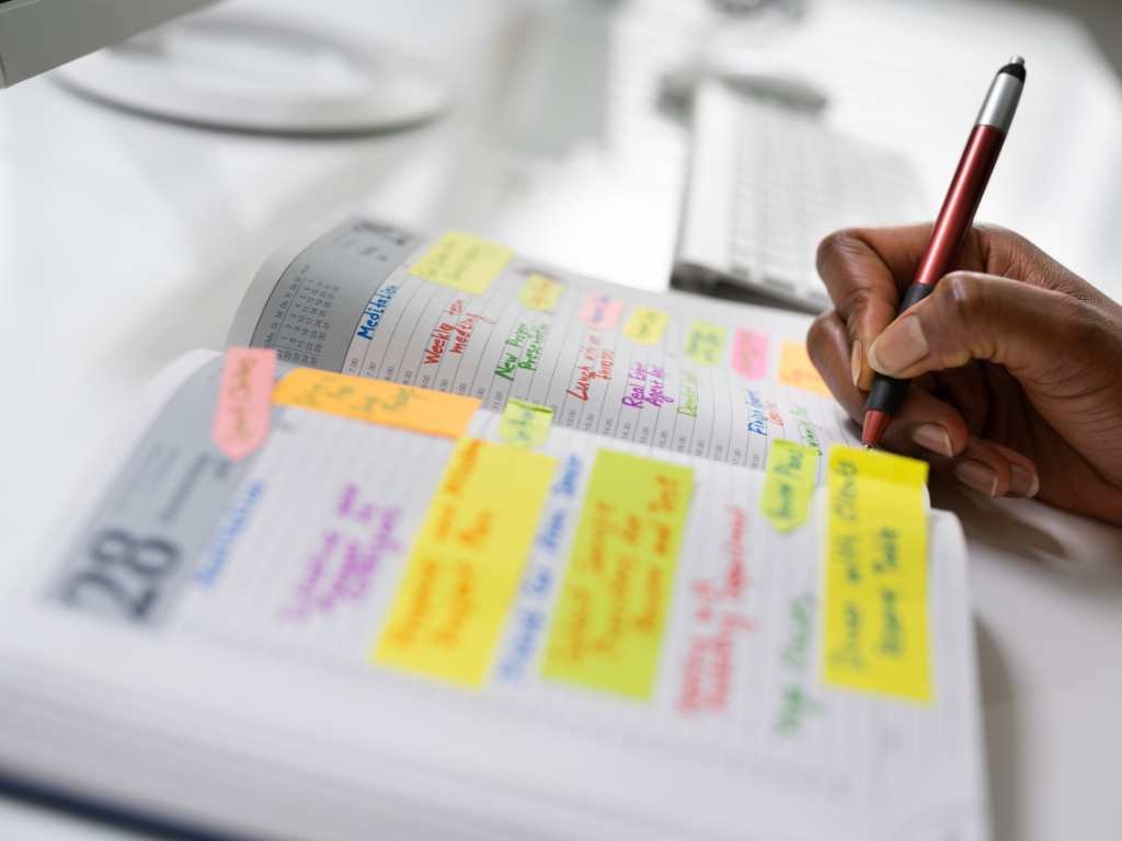 open planner on the table with post-its and notes