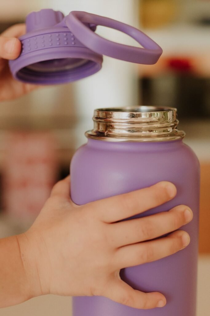 purple tumbler being opened by a person