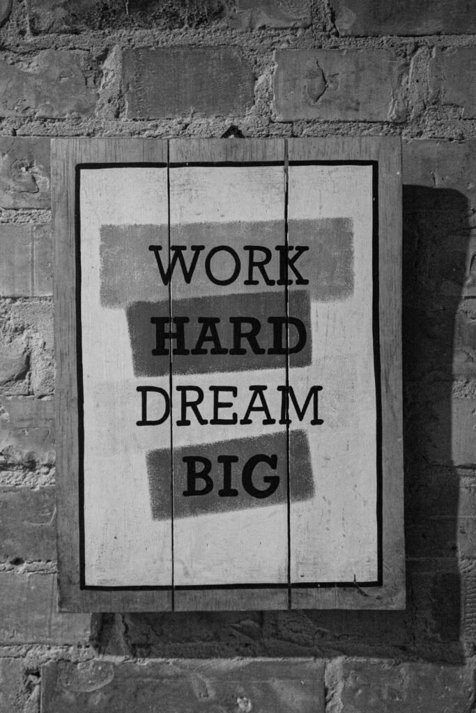 word hard dream big motivational poster framed on a wall