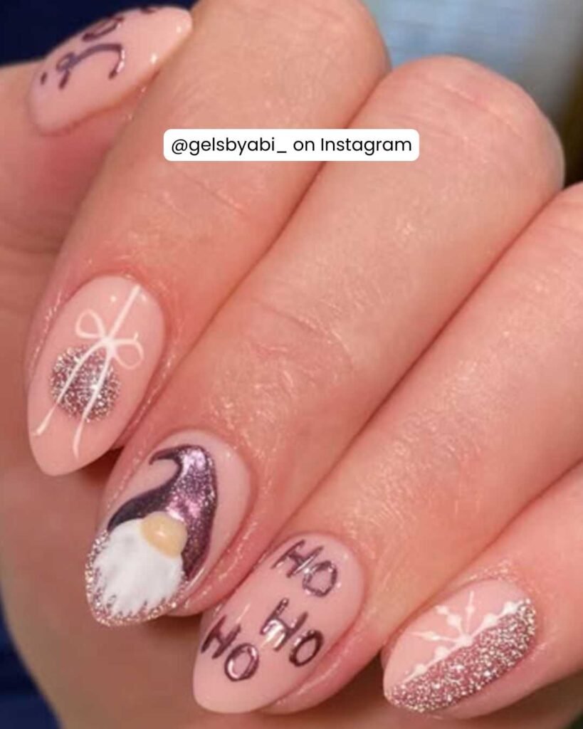 Sparkling pink nails with a gnome design, glitter accents, gift bows, and playful "Ho Ho Ho" lettering.