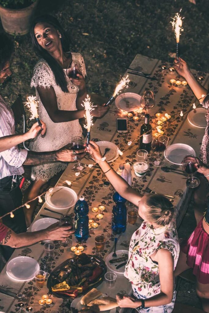 friends at a long table during a night gathering