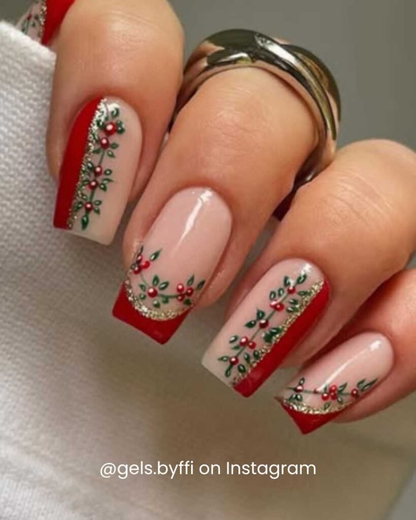 Red French tip nails with holly berry accents and shimmering silver details for a classic Christmas look.
