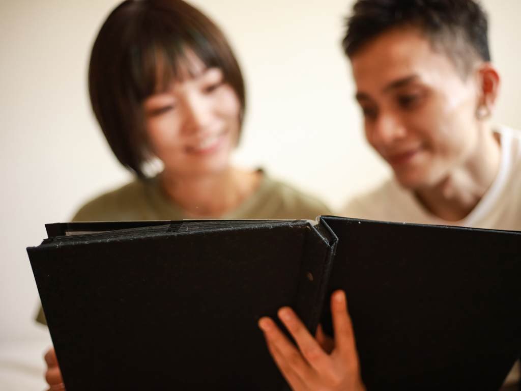 asian and black student reading a yearbook