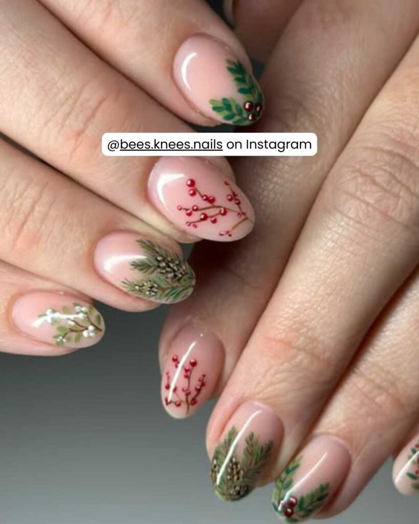 Minimalist nails with evergreen sprigs, red berry accents, and a soft nude base.