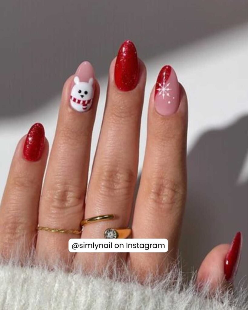 Playful nails featuring a polar bear in a scarf, red glitter, and delicate white starburst details.