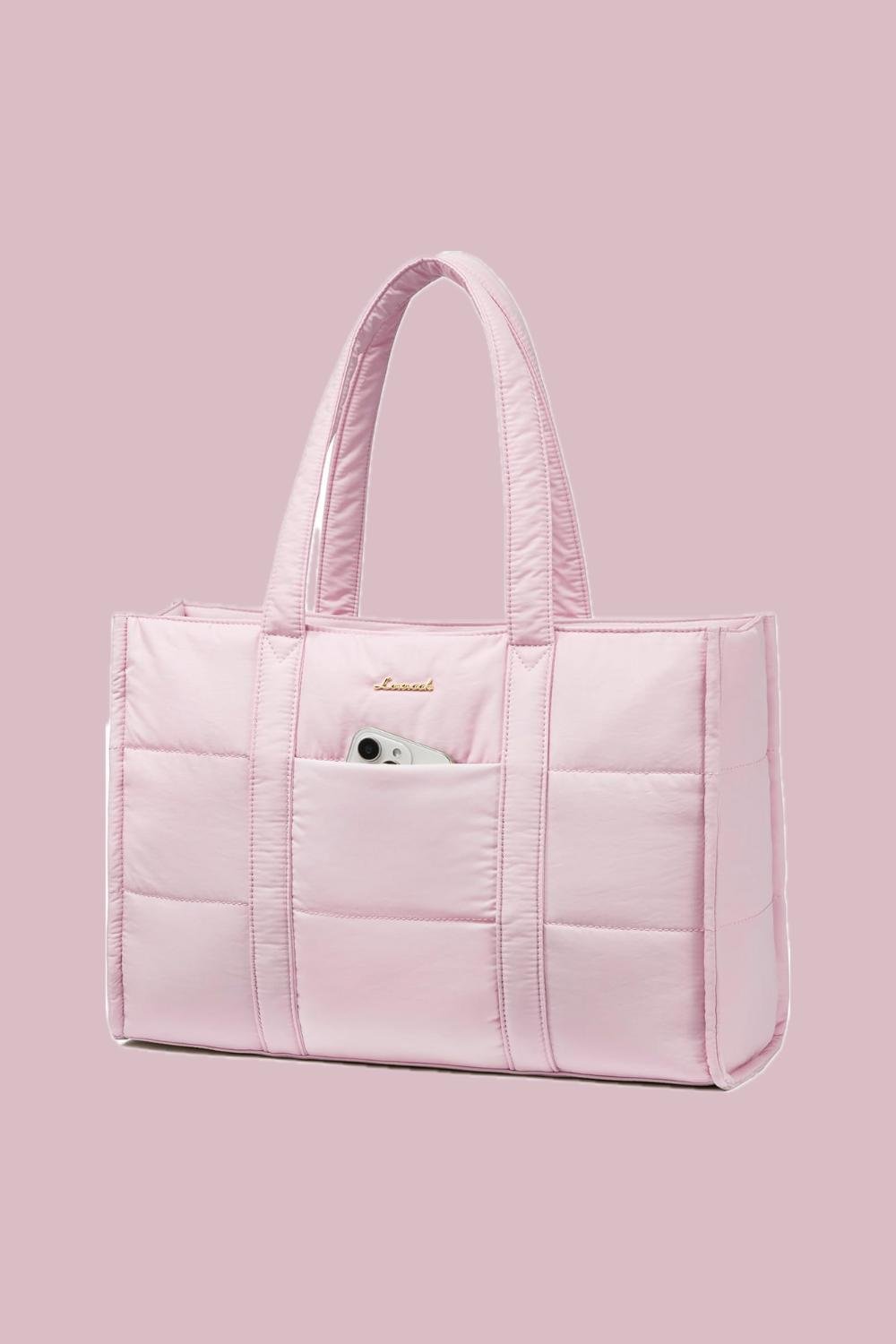 A pink puffy tote bag with a phone placed in its front pocket.