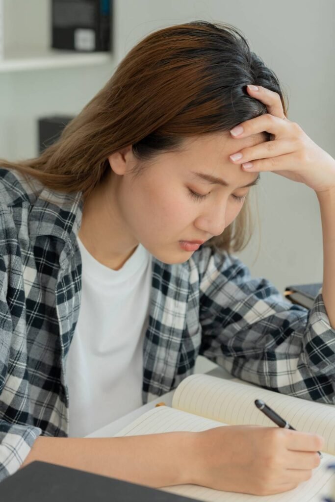 Young Asian student doing her homework at her desk
