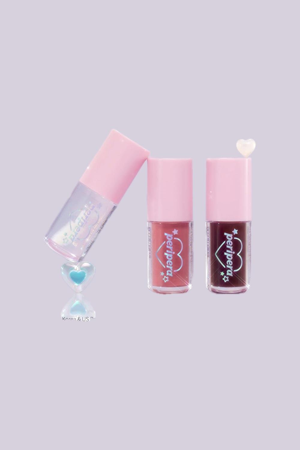 Three lip glosses in different shades. 