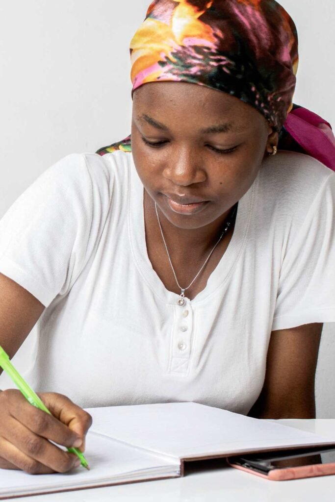 young black woman wearing a white shirt studying for an exam