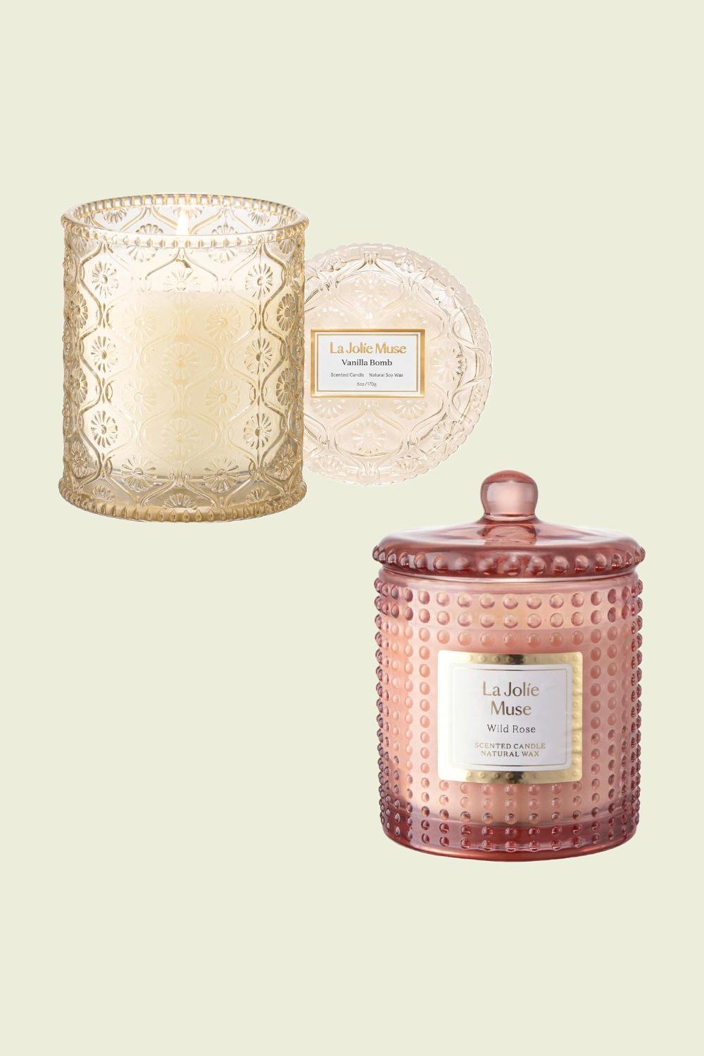 Two scented candles, one in gold and the other in rose gold.