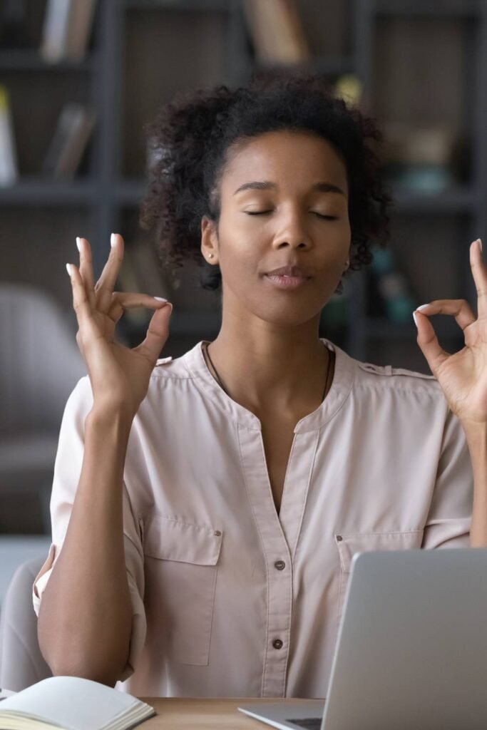 Young black woman being in a zen state while sitting down