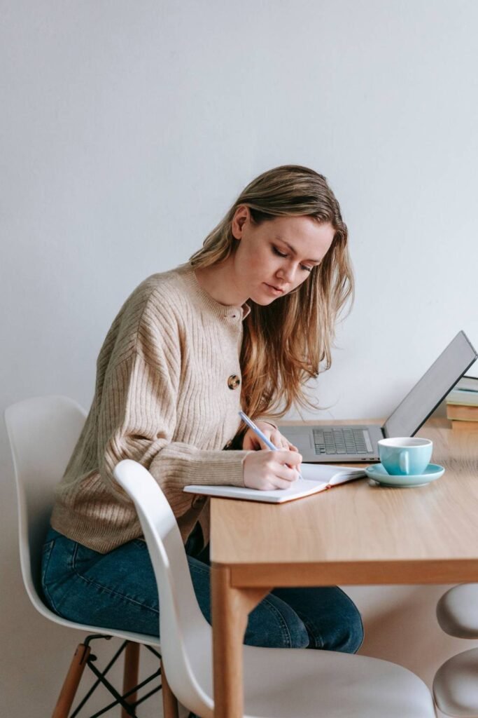 Young blonde student studying at her desk