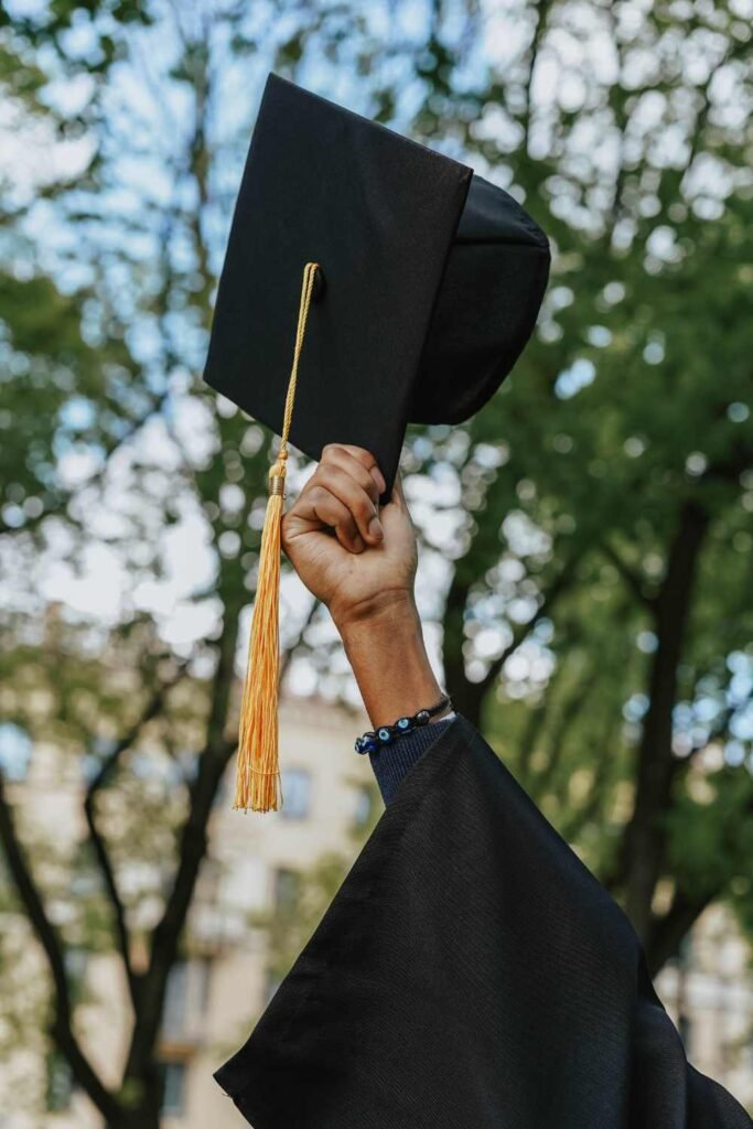 graduation hat being held up in the air